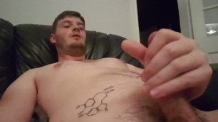 Tattooed science nerd strokes off on the sofa