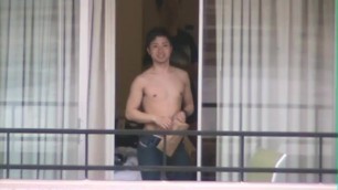 asian guys in hotel window wave